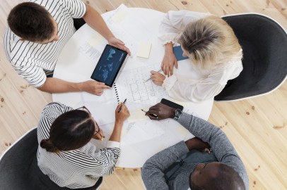 Close up on young colleagues having a meeting, view from top down