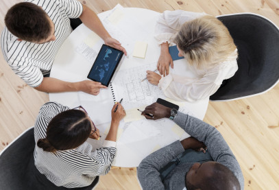 Close up on young colleagues having a meeting, view from top down