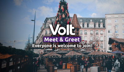 Volt Meet & Greet. Everyone is welcome to join. In the background a big christmas tree and some christmas market huts are seen at the Place de Paris in Luxembourg city.