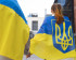 Back view of people wearing Ukranian flags