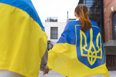 Back view of people wearing Ukranian flags