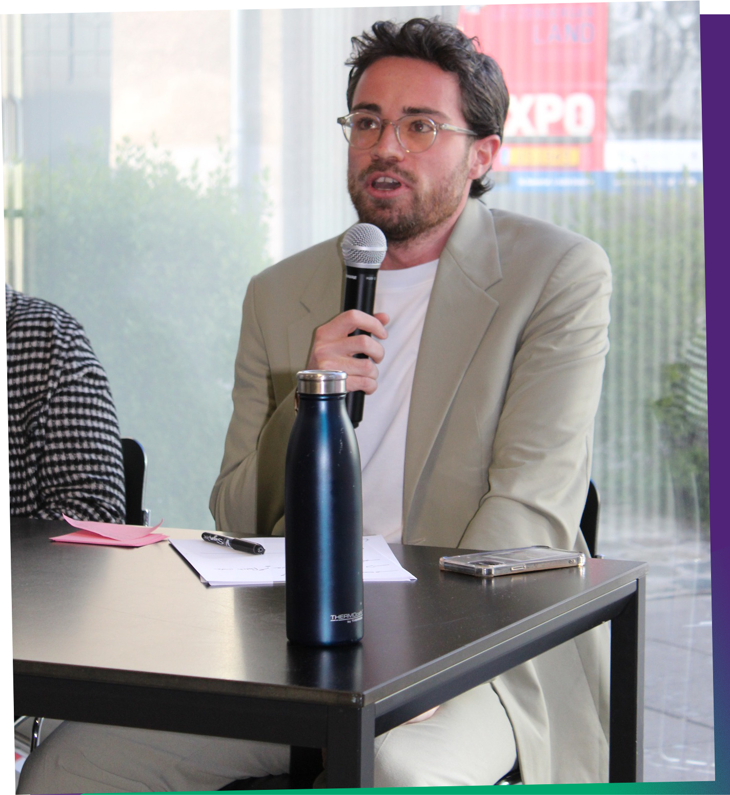 Samuel Moïse speaking into a microphone
